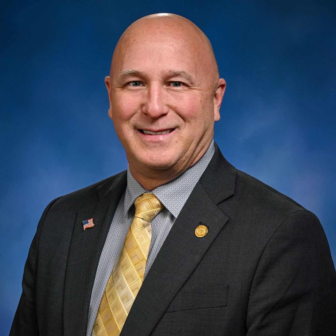 Michigan Rep. Jay DeBoyer, R-Clay, headshot, blue background.