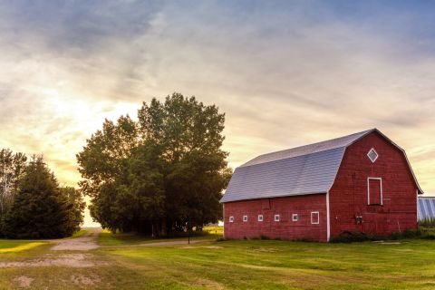 A red barn at sunset. 