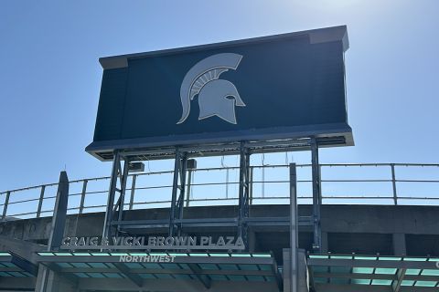 A green Spartan scoreboard on a sunny day. 
